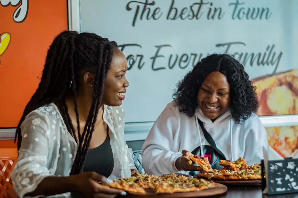 Two friends sharing a meal at a restaurant