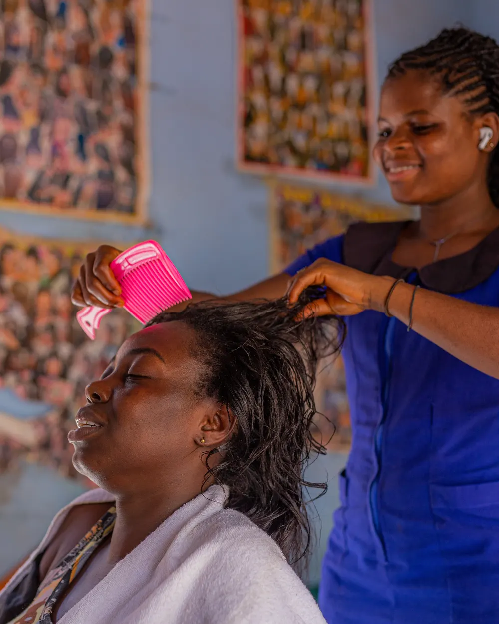 A hairdresser styling a client's hair in a salon